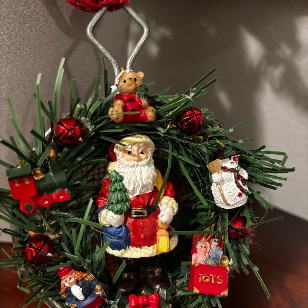 Handmade Santa Holiday Wreath on an old tea strainer.